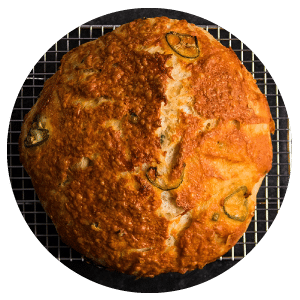 loaf of cheese bread on a wire rack