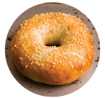 Bagel topped with sesame seeds on a baking sheet