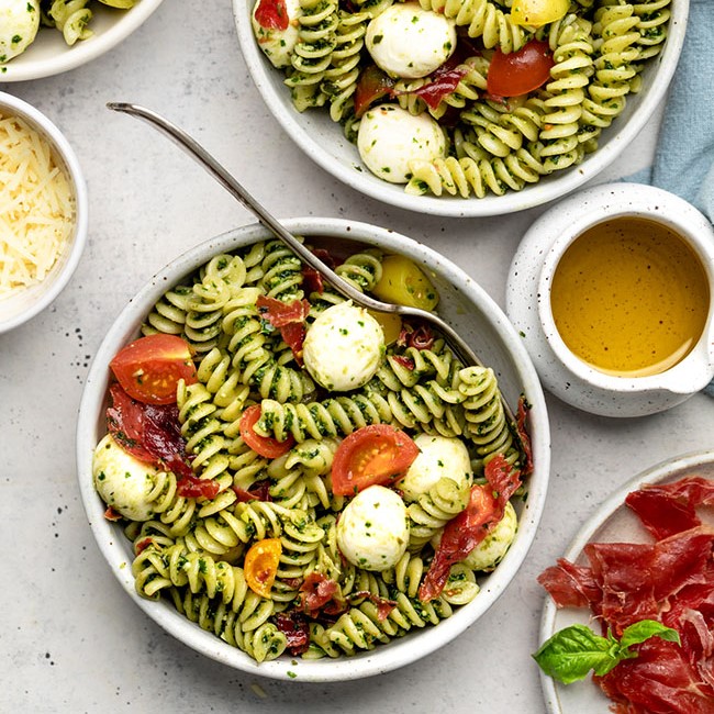 pasta salad with pesto, tomatoes, and mozzarella