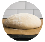 unbaked bread dough on a piece of parchment paper